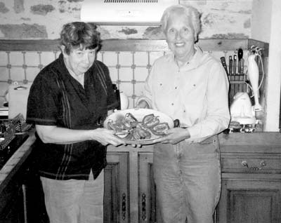 Catherine Grisé (left) and Lorna Tjaden, in Catherine’s kitchen, with red peppers stuffed with fennel — Issepts, France.